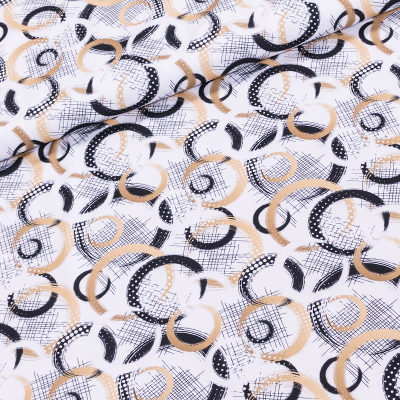 Polyesterový úplet  40936, zlaté a černé kruhy na bílé, š.150cm (látka v metráži)